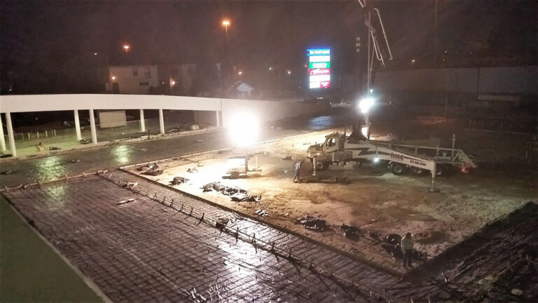 LA Fitness Center Houston TX - nighttime site work with concrete pump truck and workers on rebar grid, Keeton Construction Services