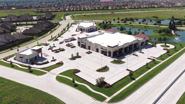 Aerial view of Bella Piazza Retail Center site showing buildings and parking area, Richmond, TX - Keeton Construction Services