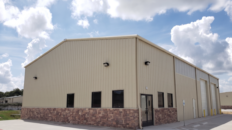 Exterior corner of a metal building at FM 529 Business Park Office/Warehouse Flex Space Phase I in Houston, TX by Keeton Construction Services, showing a personnel door and overhead door