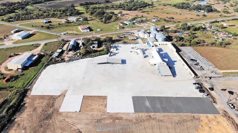 Aerial view of the Alpine Site Services project site in Edna, TX by Keeton Construction Services, showing paved yard areas and buildings