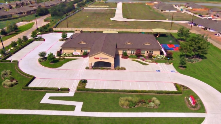 Aerial view of the Kiddie Academy Child Care Savannah Lakes building and parking lot in Rosharon, TX, by Keeton Construction Services