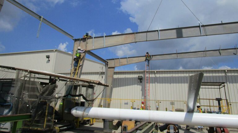 Socotherm Gulf of Mexico in Channelview, TX - workers on ladders installing a steel beam at an industrial facility, Keeton Construction Services