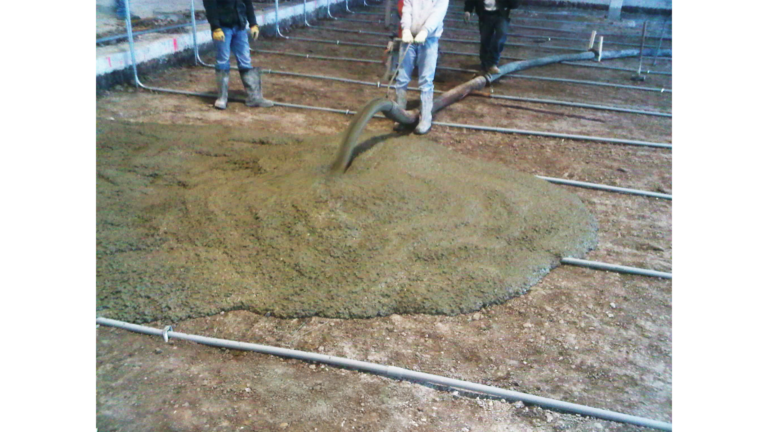Penske Logistics in Houston TX - concrete placement during construction by Keeton Construction Services, workers pumping concrete over floor grid