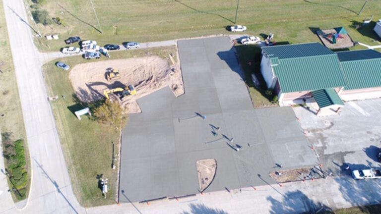 Aerial view of Fountain of Life Church of God site work in Cypress, TX by Keeton Construction Services, showing parking area and grading during construction