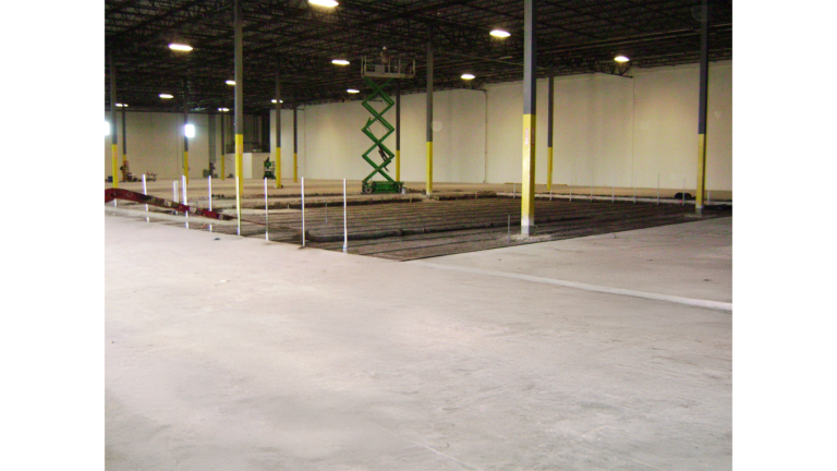 Penske Logistics in Houston TX - interior warehouse space during construction by Keeton Construction Services, concrete floor and scissor lift visible