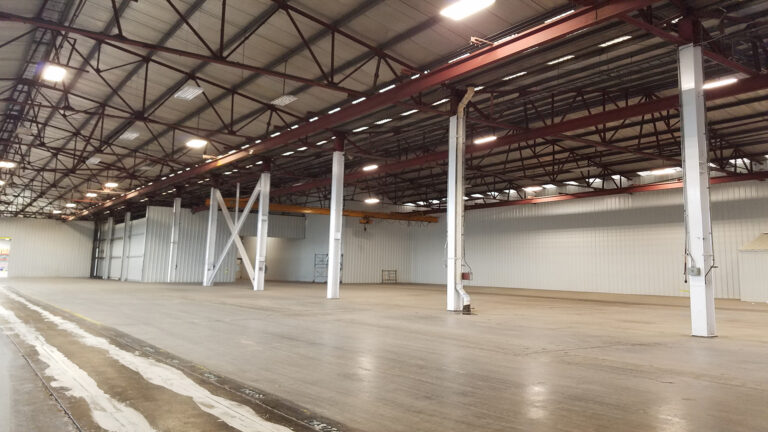 Wide interior view of the National Oilwell Varco facility in Houston TX showing columns and overhead cranes, a Keeton Construction Services project