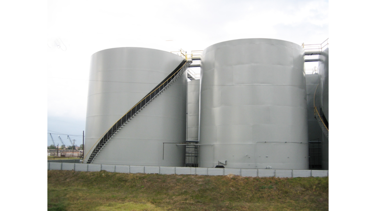 Jacob Stern and Son project in Houston, TX - two large industrial storage tanks viewed from ground level, by Keeton Construction Services