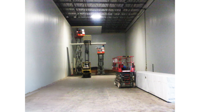 Penske Logistics in Houston TX - interior space during construction by Keeton Construction Services, scissor lifts and forklift in work area