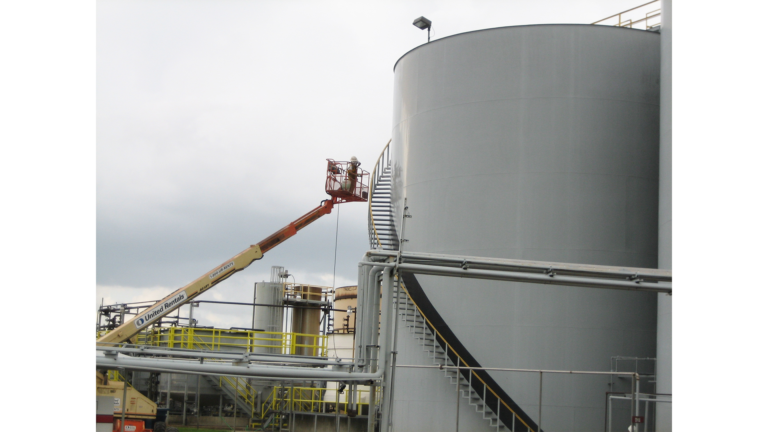 Jacob Stern and Son project in Houston, TX - boom lift operator working at the upper section of a large industrial tank, by Keeton Construction Services
