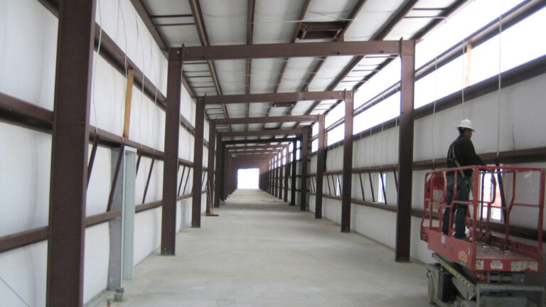 Helix Energy Solutions Spool Base in Ingleside, TX - interior during construction with worker on a scissor lift, by Keeton Construction Services