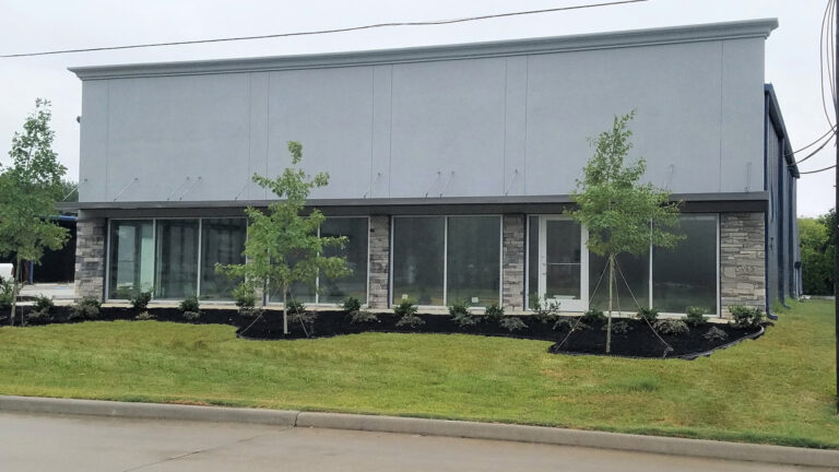 Front facade of the office building at Legacy Business Park in Cypress TX with large windows and landscaping by Keeton Construction Services
