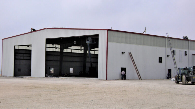 Helix Energy Solutions Spool Base in Ingleside, TX - metal building end-wall with open bay doors during construction, by Keeton Construction Services