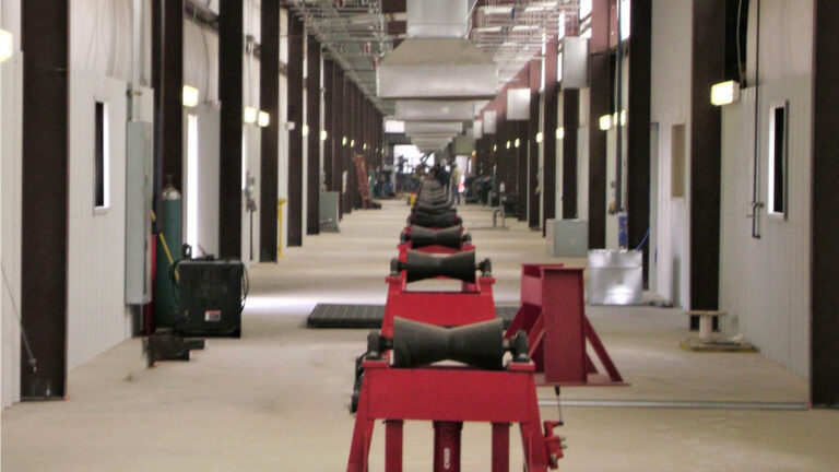 Helix Energy Solutions Spool Base in Ingleside, TX - interior of the building showing a row of pipe support stands, by Keeton Construction Services