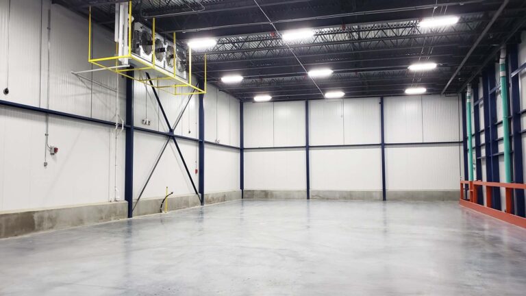 Interior warehouse bay corner at the Labatt Food Service facility in Houston, TX with overhead equipment unit, Keeton Construction Services