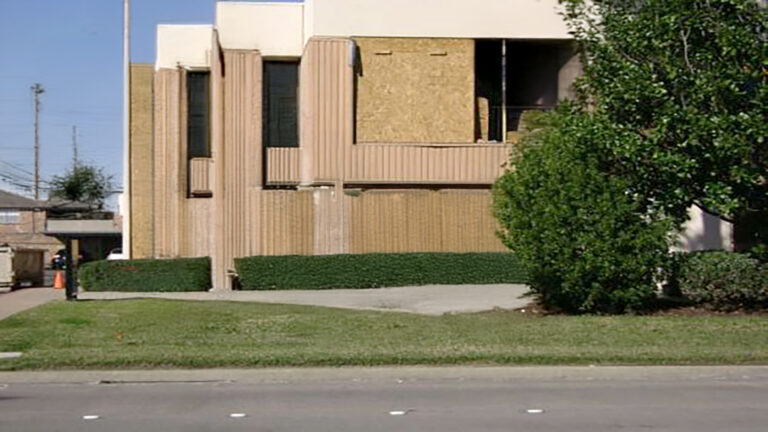 American Spectrum exterior street view, Houston, TX - Keeton Construction Services building facade with sheathing panels on the upper section and landscaping in front