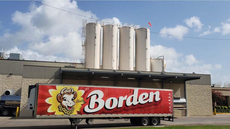 Borden Dairy exterior with delivery truck and silos visible in Houston, TX - Keeton Construction Services