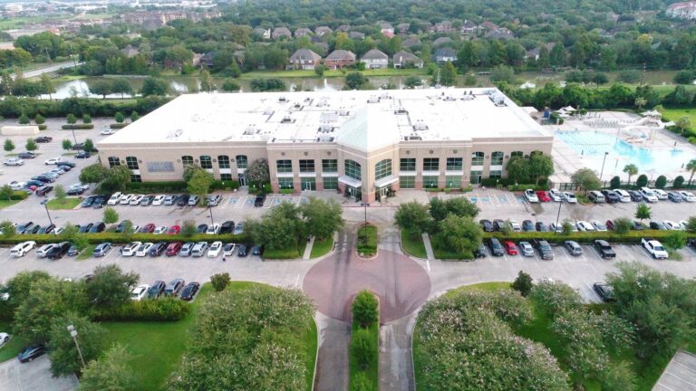 Aerial view of the Lifetime Fitness building and parking area in Sugarland, TX, a project by Keeton Construction Services