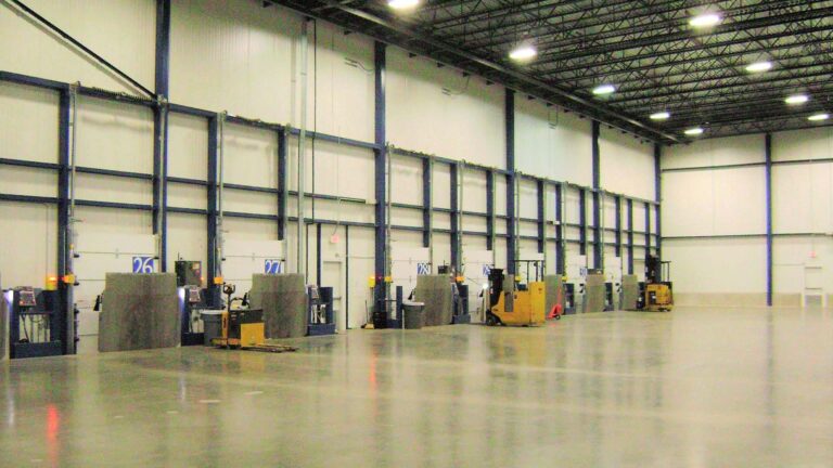 Interior loading dock area at Jakes Finer Foods in Houston, TX by Keeton Construction Services, showing dock doors and forklifts inside the warehouse