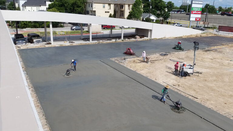 LA Fitness Center Houston TX - workers finishing a freshly poured slab during construction, Keeton Construction Services