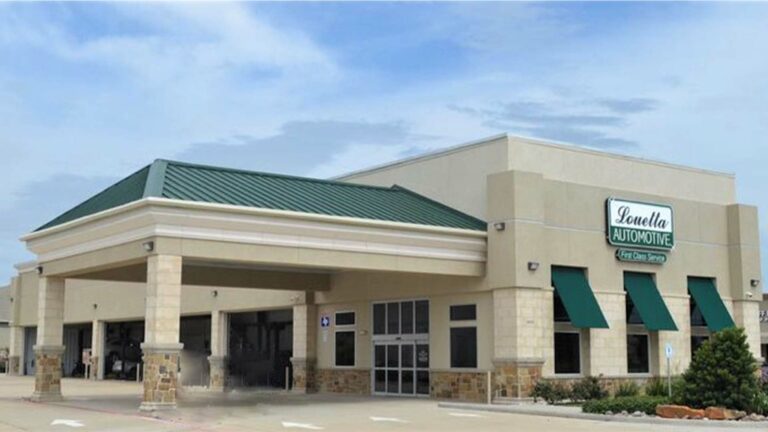 Exterior of the Louetta Automotive building in Katy TX, a project by Keeton Construction Services, showing the front facade and covered service canopy