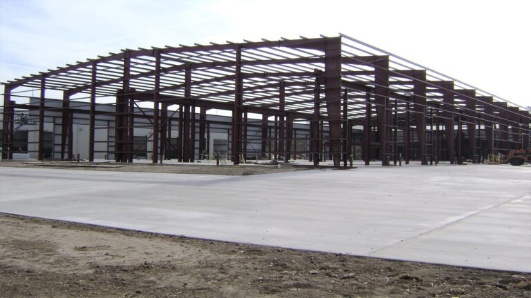 Structural steel framing during construction at Master Rig International in Houston, TX by Keeton Construction Services with bare dirt on the surrounding site