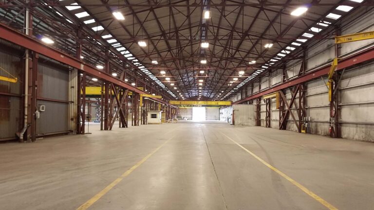 National Oilwell Varco facility interior in Houston TX showing an empty industrial bay with overhead cranes, a Keeton Construction Services project