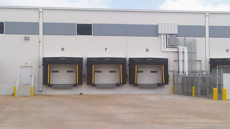 Penske Logistics in Houston TX - exterior dock doors on the warehouse building by Keeton Construction Services, numbered bays with dock levelers
