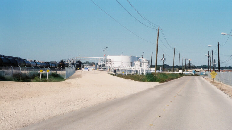 Shell Oil Refinery, Pasadena, TX - site road with railcars and industrial tanks in the background, Keeton Construction Services