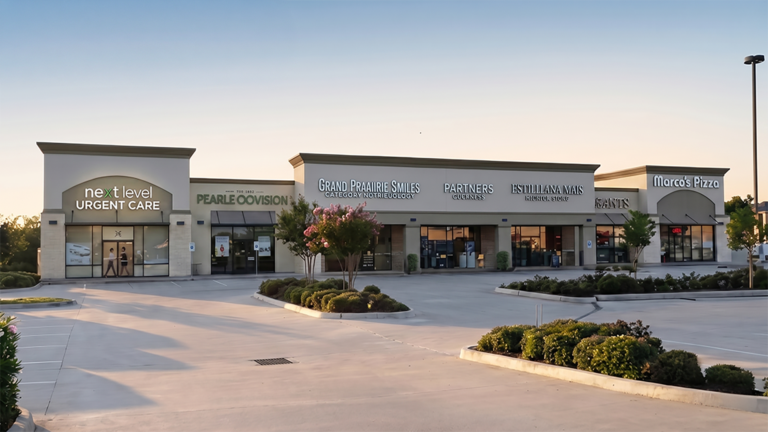 Exterior of Long Meadow Farms Retail Center in Houston TX, Keeton Construction Services, ground-level view of storefronts and parking lot at dusk