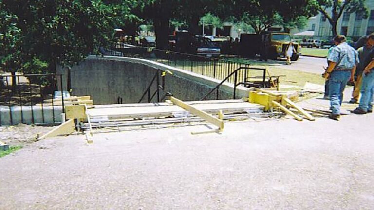 University of Houston site work in progress, Houston, TX - Keeton Construction Services crew and materials on campus pathway during construction
