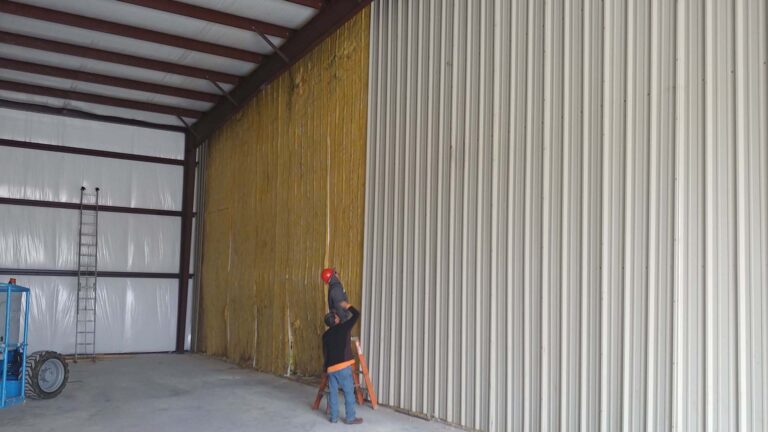 Precision Piping Products interior during construction in Houston TX by Keeton Construction Services, workers installing wall insulation