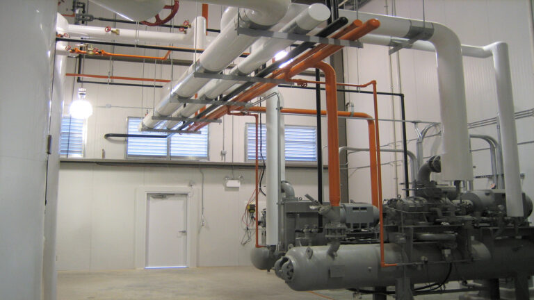 Interior mechanical room at the Labatt Food Service facility in Houston, TX with overhead piping and equipment, Keeton Construction Services