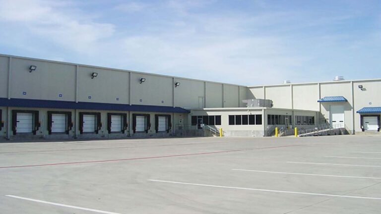 Loading dock side of Jakes Finer Foods in Houston, TX by Keeton Construction Services, showing multiple dock doors and a paved truck court