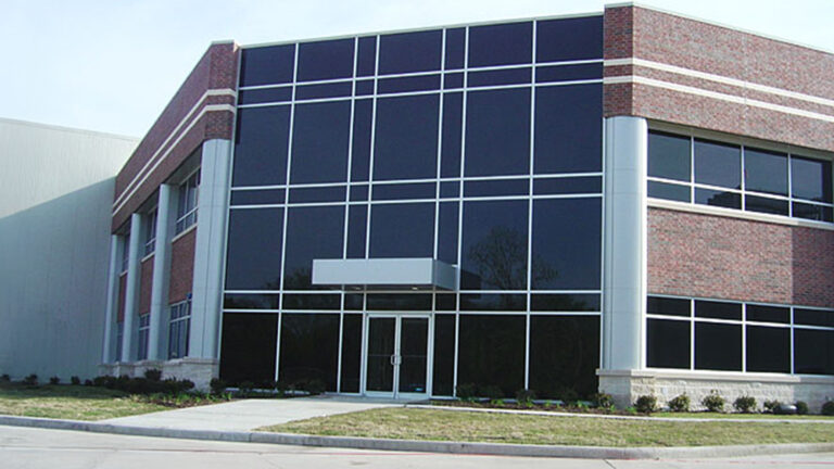 Main entrance of Jakes Finer Foods in Houston, TX by Keeton Construction Services, showing the glass curtain wall and masonry facade