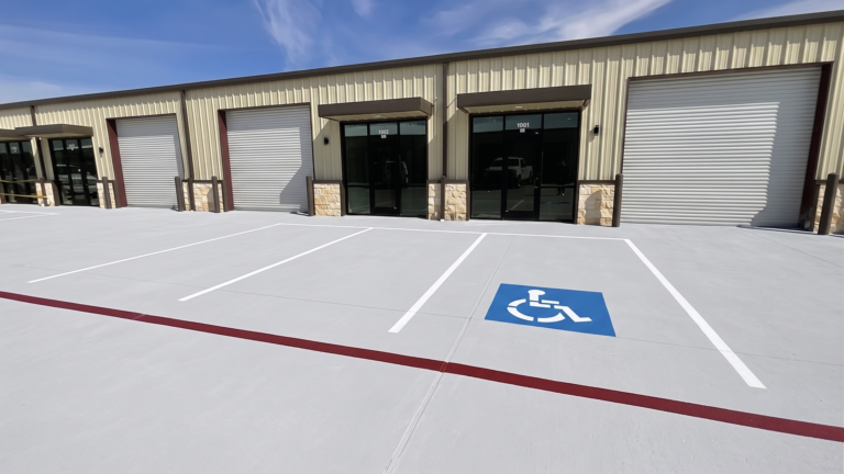 Exterior view of FM 529 Business Park Phase II units in Katy TX showing roll-up doors and accessible parking area by Keeton Construction Services