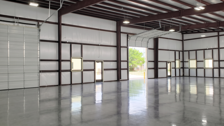 Interior of a warehouse bay at FM 529 Business Park Phase II in Katy TX with roll-up doors and structural framing by Keeton Construction Services