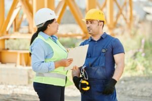 Houston construction management talking to construction worker