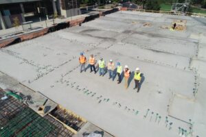 construction professionals standing on foundation for Houston turnkey general construction project