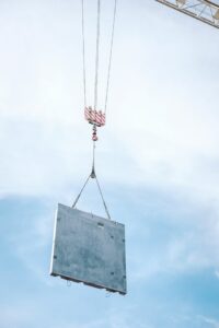 Concrete panel lifted by crane by Houston commercial concrete contractor for tilt wall construction