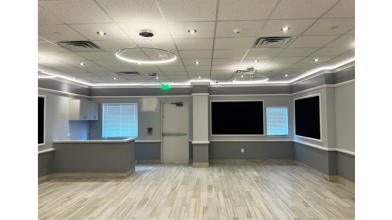Interior classroom with open floor area and wall-mounted screens at Prescolaire Early Learning Academy Spring, Keeton Construction Services, Spring, TX