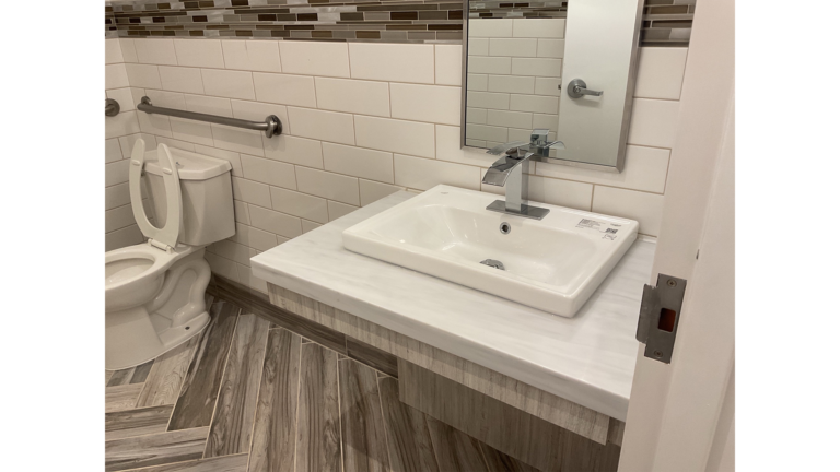 Bathroom with single sink vanity, toilet, and grab bar at Prescolaire Early Learning Academy Spring, Keeton Construction Services, Spring, TX