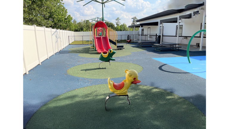 Outdoor playground with play equipment and rubber surfacing at Prescolaire Early Learning Academy Spring, Keeton Construction Services, Spring, TX