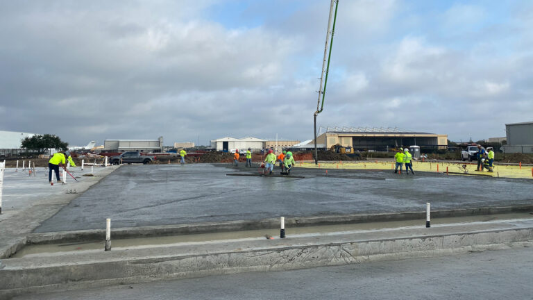 Crew finishing a freshly poured slab at Houston Signature Flight Support Hobby, Houston, TX - Keeton Construction Services