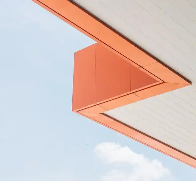 Edge of commercial building developed by general contractor contrasted against the sky