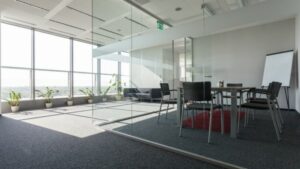 Interior of healthy building with glass walls, plants, windows as developed by Houston general contractor