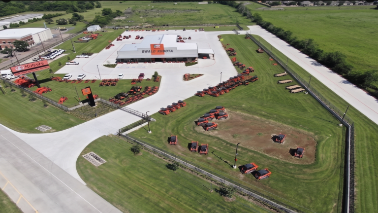 Wide aerial view of Ewald Kubota Equipment Dealership Rosenberg TX showing the building and surrounding lot, Keeton Construction Services