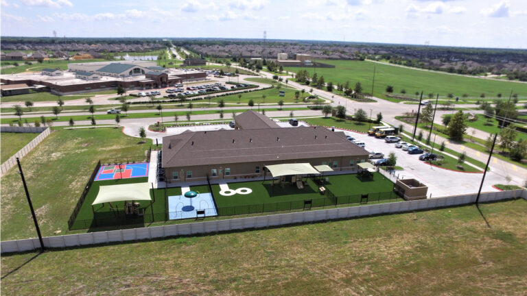 Elevated rear view of the Day Care Center Development showing outdoor play areas by Keeton Construction Services in Rosenberg, TX