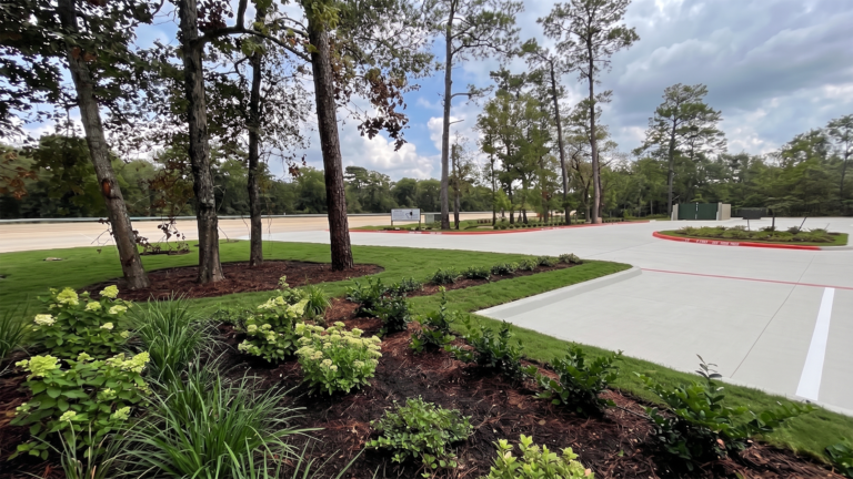 Little Texans Day Care Center entry drive with trees and planted landscaping, Conroe, TX - Keeton Construction Services