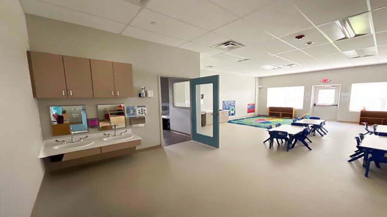 Little Texans Day Care Center interior room with sinks, mirrors, cabinetry and child-height tables and chairs, Conroe, TX - Keeton Construction Services