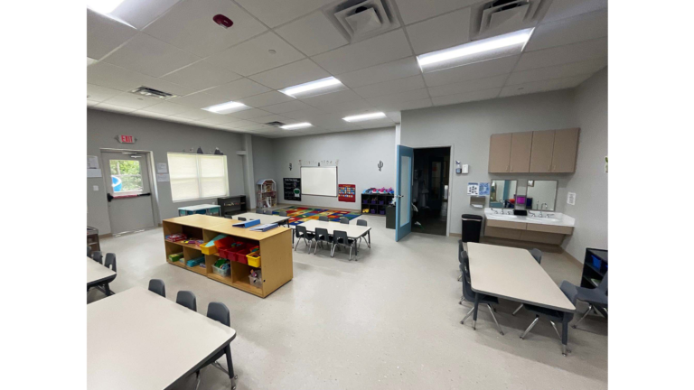 Little Texans Day Care Center interior classroom with tables, chairs, storage cubbies and a whiteboard, Conroe, TX - Keeton Construction Services